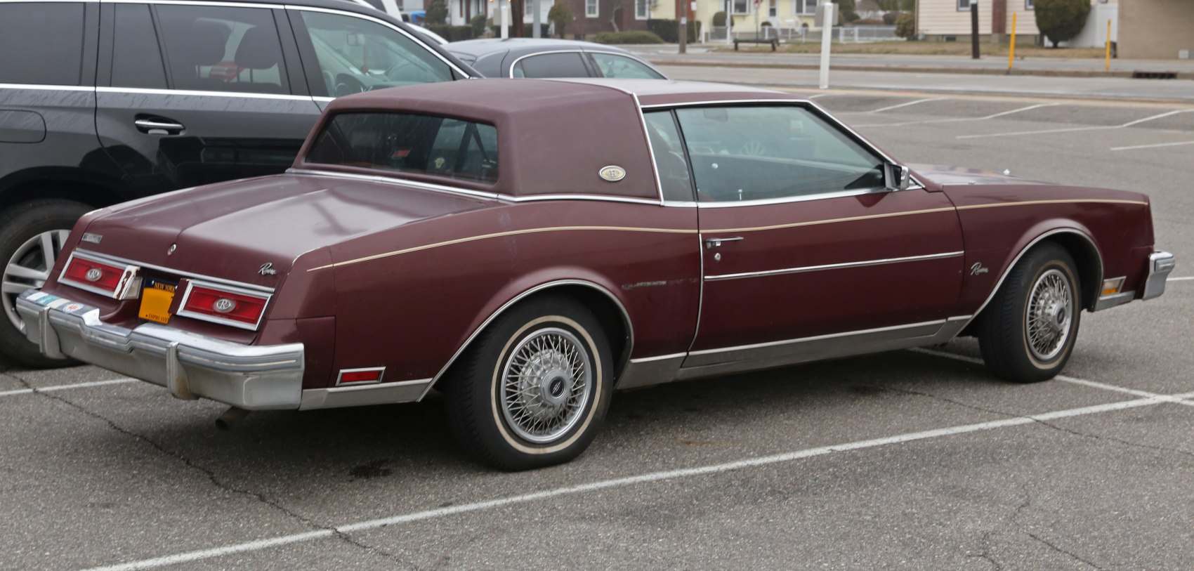 Classic two-door coupe with landau vinyl roof and wire-spoke wheels