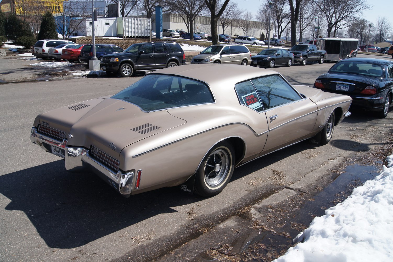 Classic beige vintage coupe with split rear window and chrome bumpers.