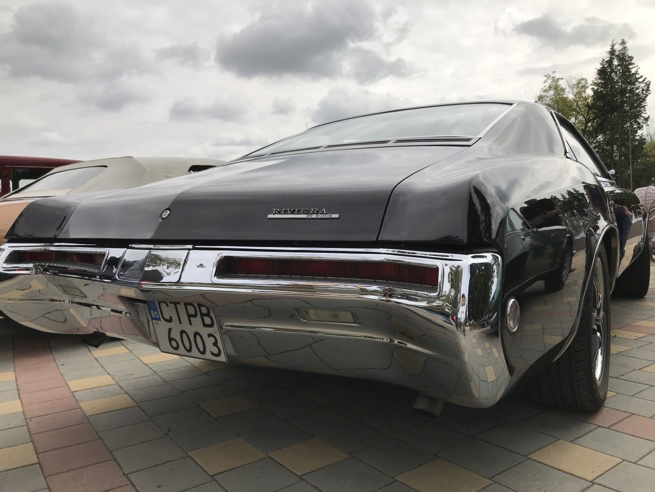 Close-up of rear bumper and tail lights with chrome trim