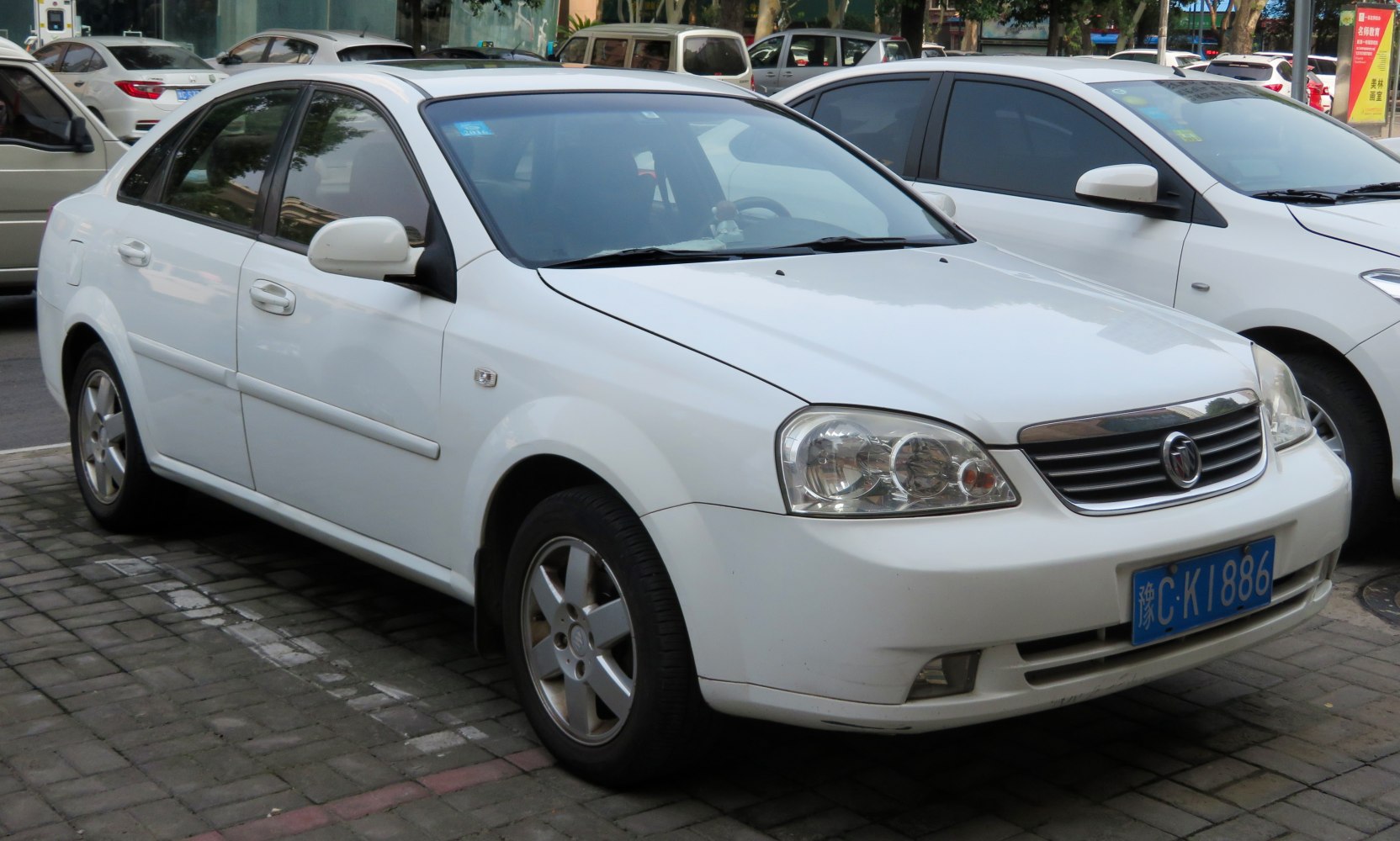 White sedan with alloy wheels and distinctive headlights