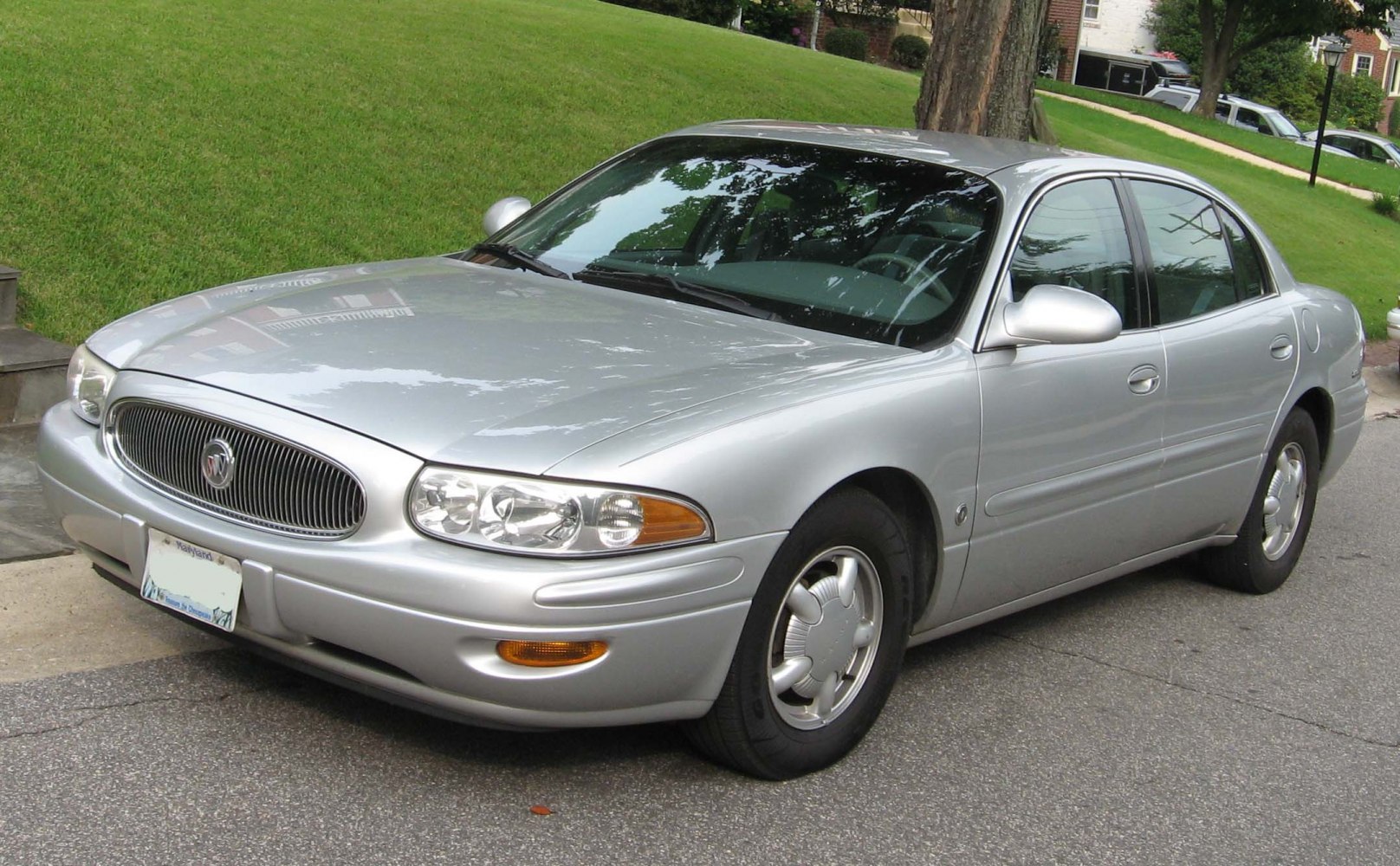 Silver mid-size sedan with round headlights and chrome grille