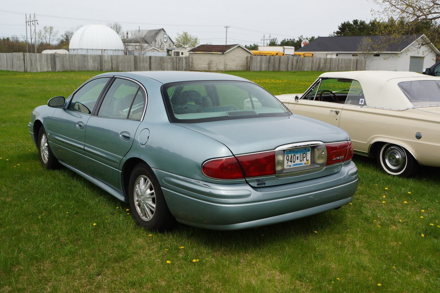 Rear view of a four-door sedan with distinctive taillights and curved trunk