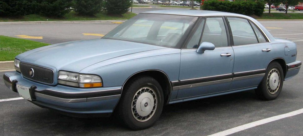 Full side profile of vintage sedan with distinctive front grille and classic design elements
