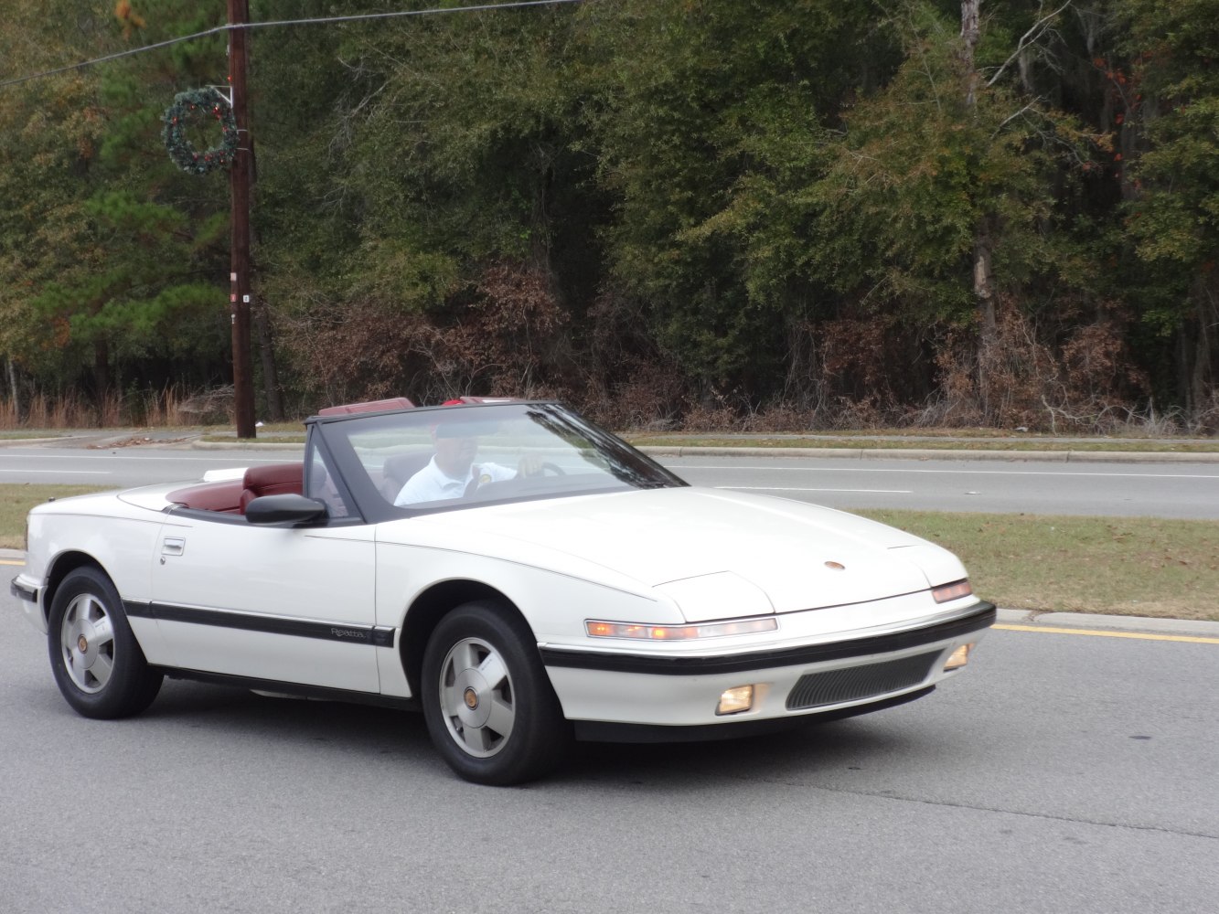 Convertible vehicle with retractable headlights and sporty wheels on road