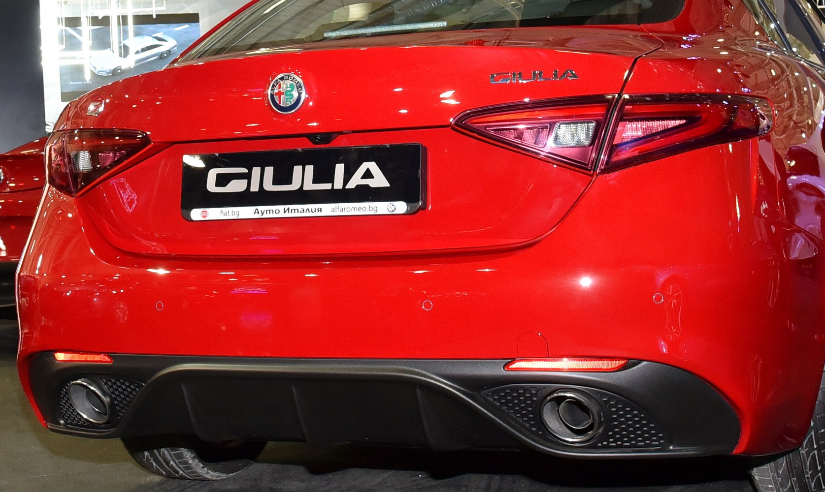 Rear view with taillights and dual exhaust on a sporty sedan