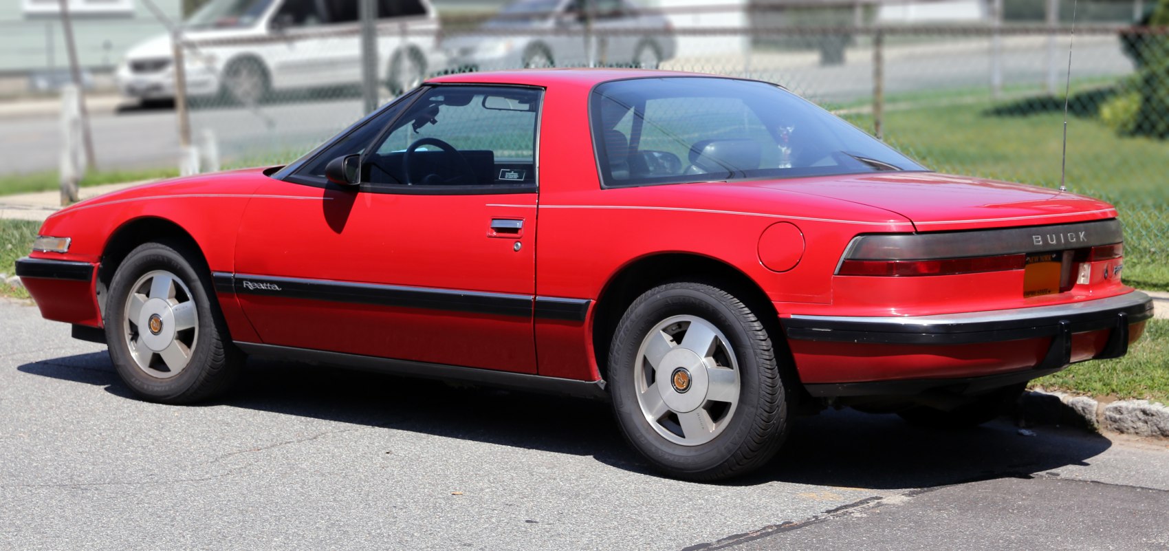 Classic red sports coupe with unique rear design and alloy wheels