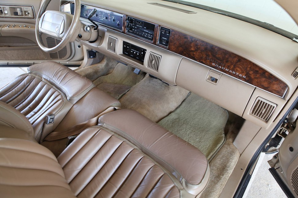 Vintage dashboard with wood accents and leather seats in beige interior