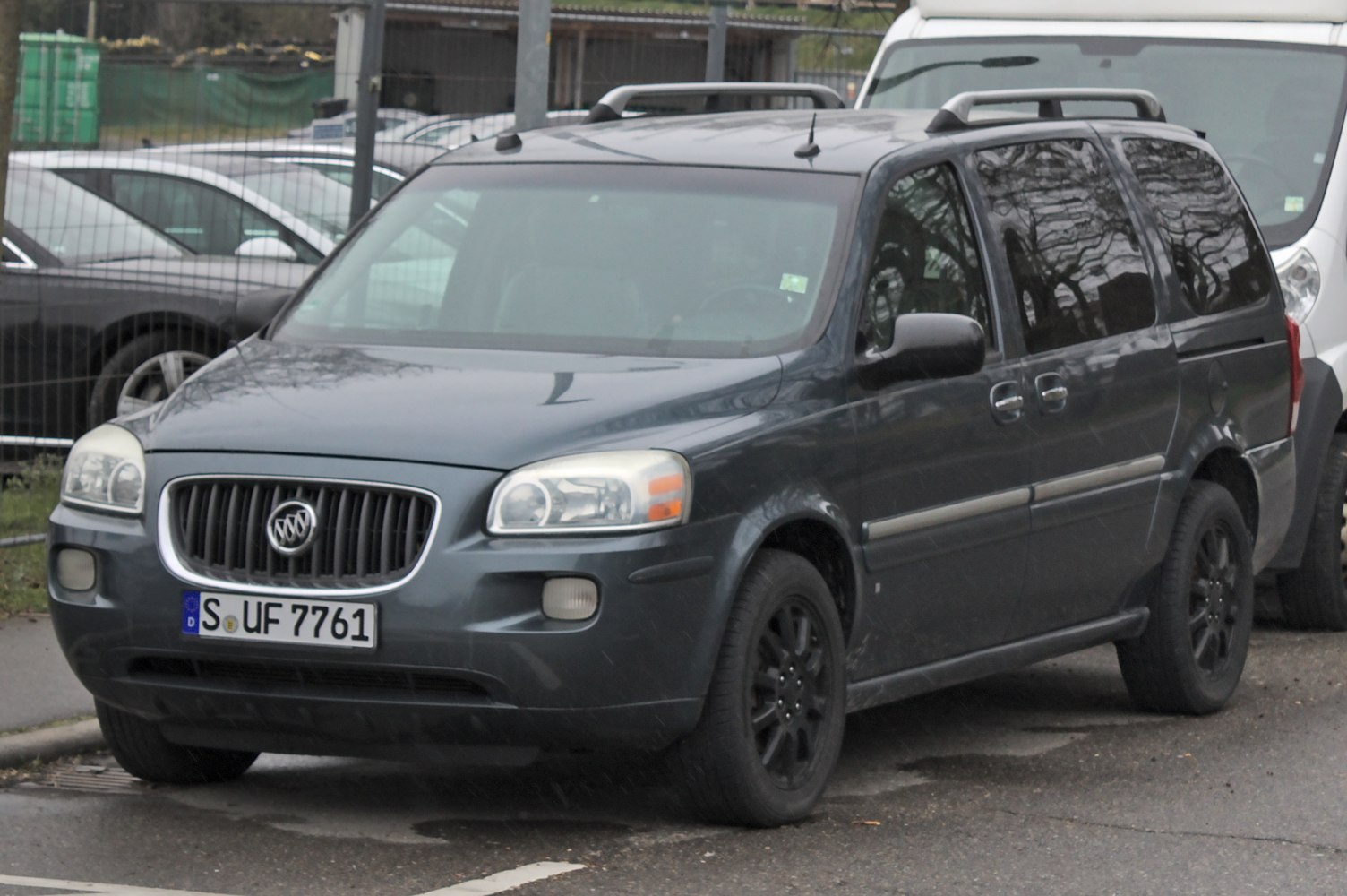 Minivan with roof rails and sliding side doors parked on street