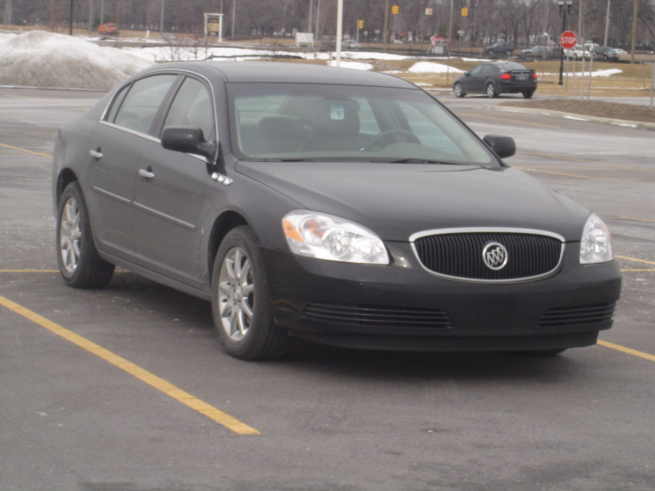 Sedan with distinct front grille and headlights in a parking lot.
