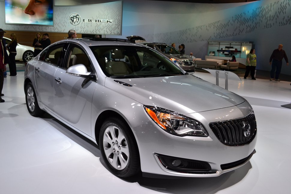 Silver mid-size sedan with distinctive headlights and bold grille, front 3-4 view