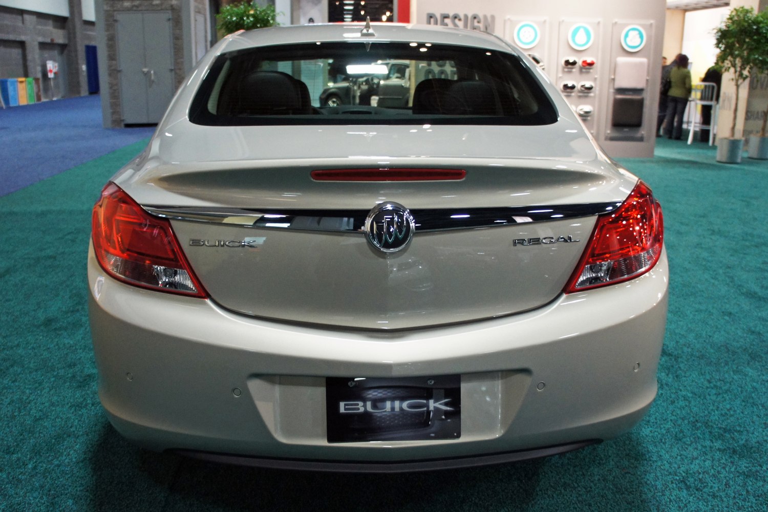 Rear view of sedan highlighting tail lights and trunk emblem