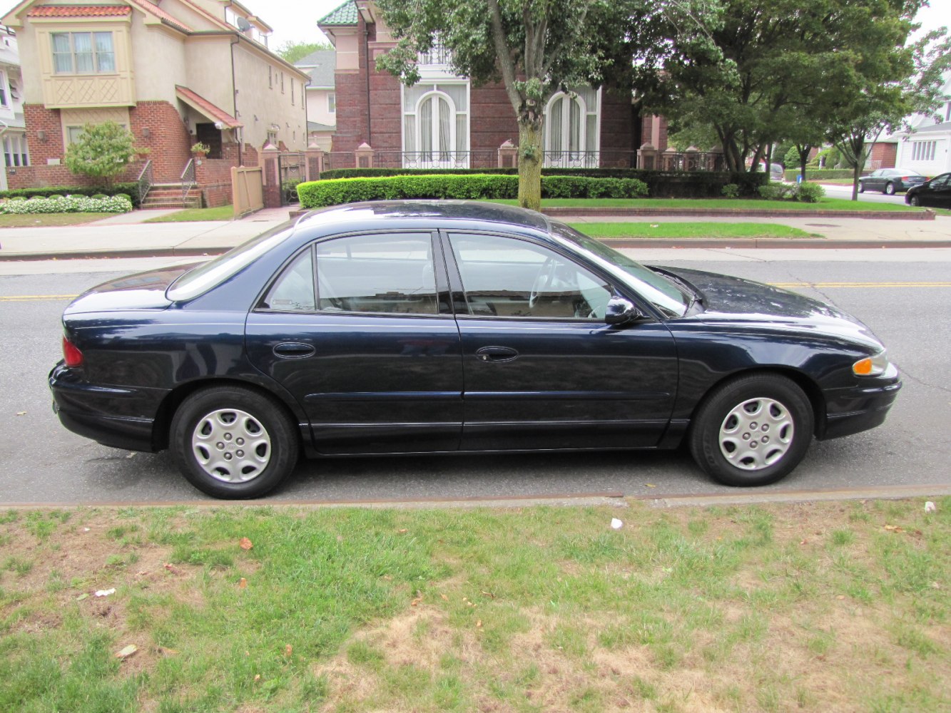 Side profile of a four-door mid size sedan with classic smooth body lines