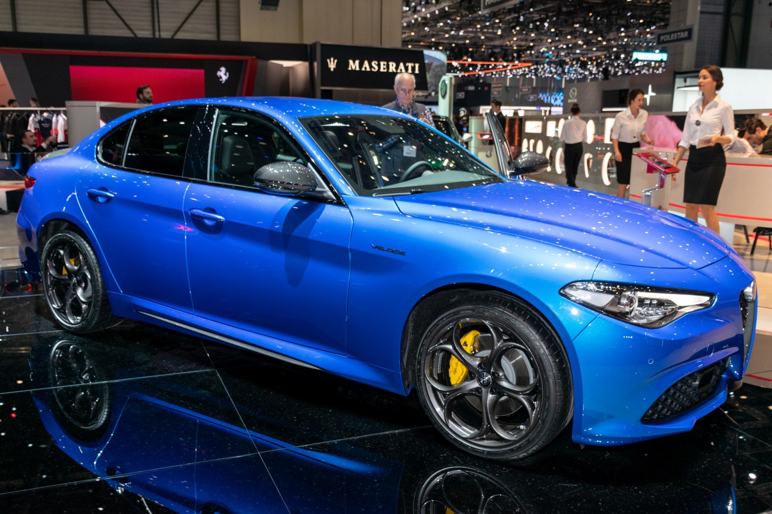 Blue sports sedan with distinctive alloy wheels and yellow brake calipers
