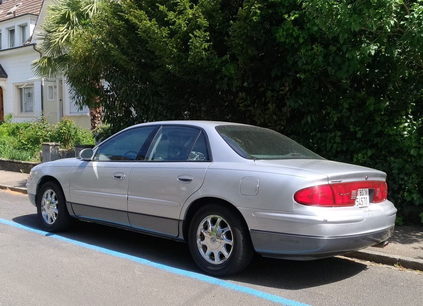 Silver sedan rear side view with smooth curves and distinctive tail lights