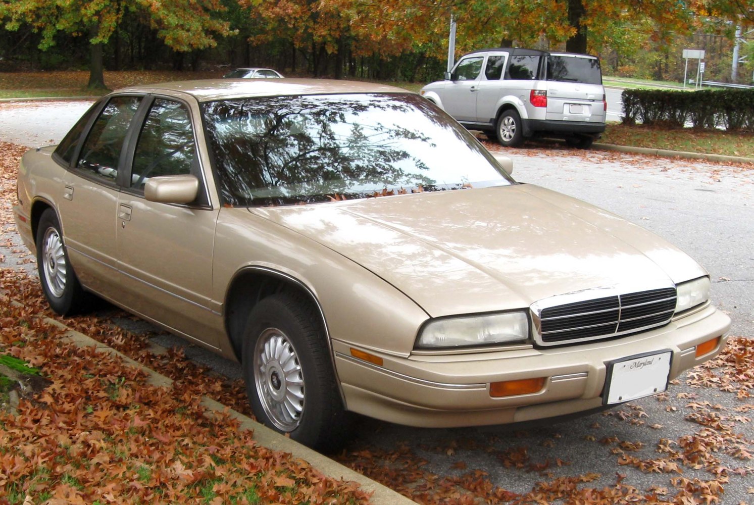 Classic early 90s sedan front side with angular headlights and beige color