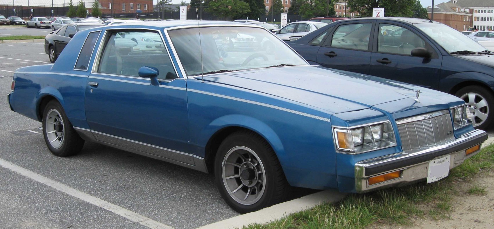 Classic blue two-door coupe with sharp styling and rectangular headlights.