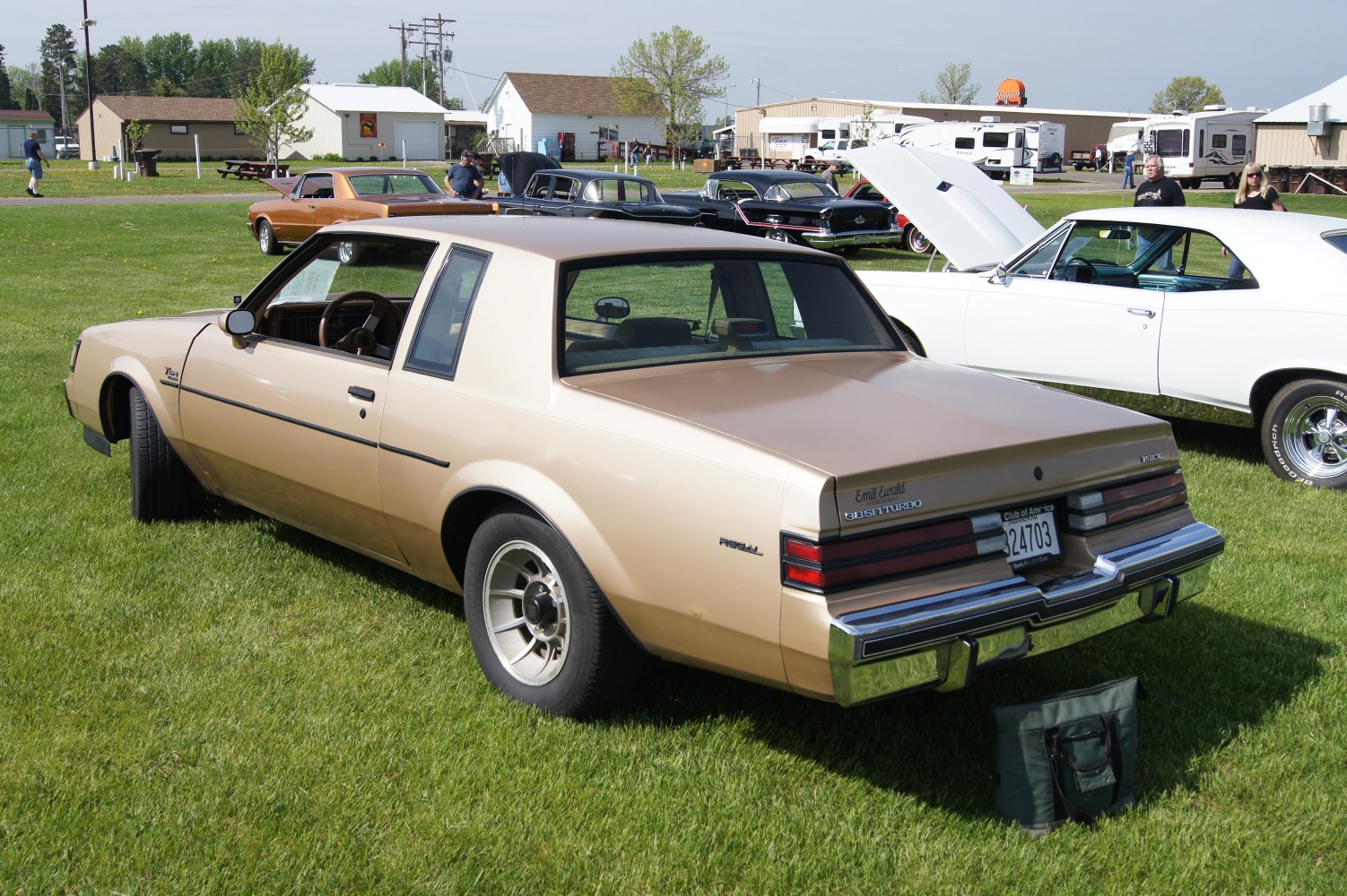 Rear view of beige two-door coupe with turbo badge and classic 1980s styling