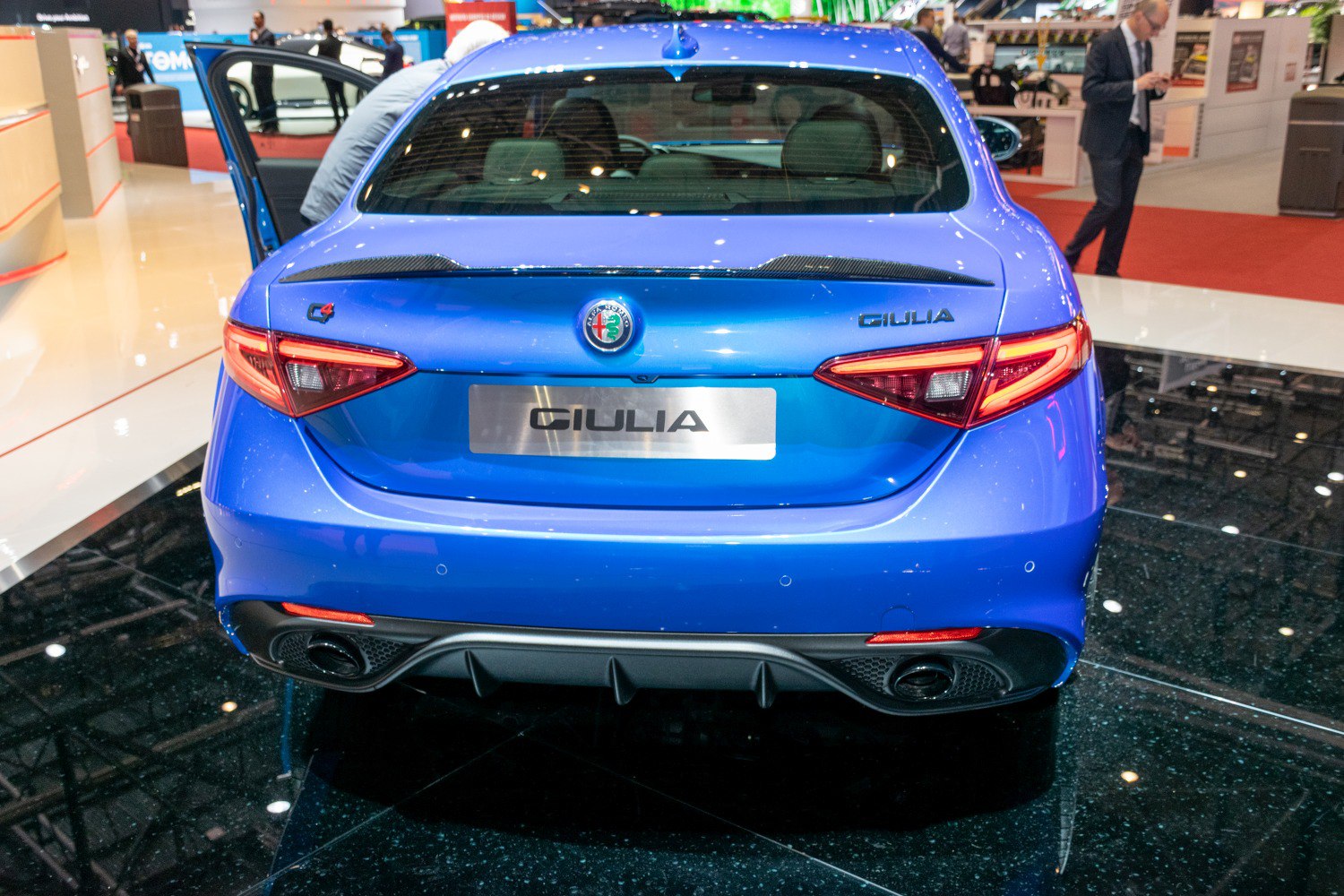 Blue sedan rear featuring LED taillights and dual exhaust system