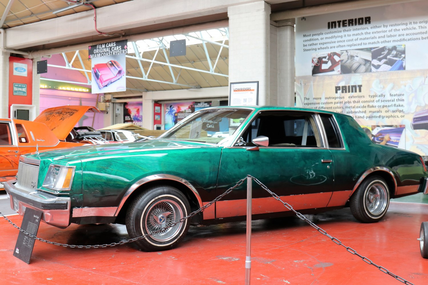 Custom painted lowrider with wire spoke wheels and two-tone green and copper finish