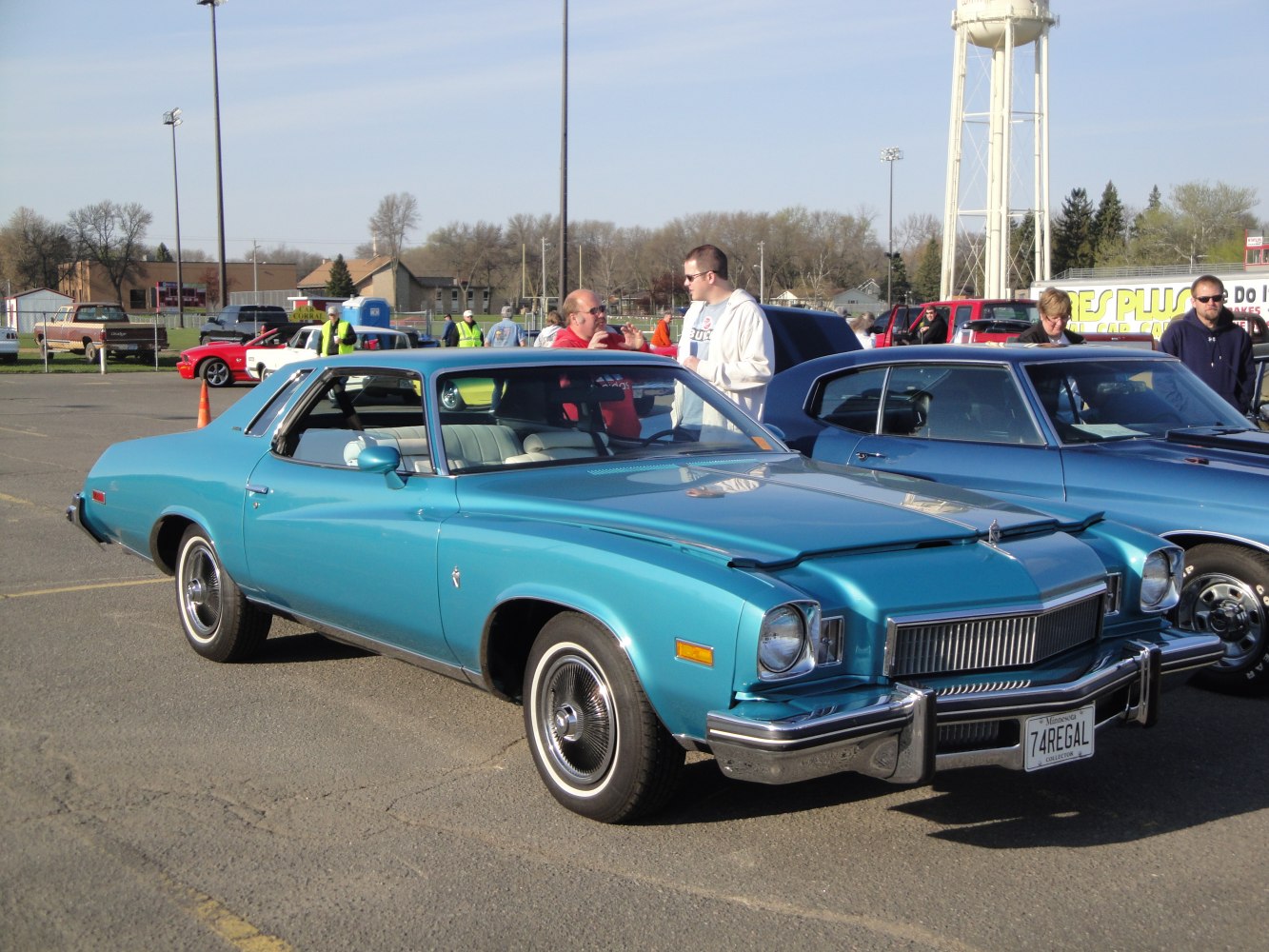 Front three-quarter view of a classic vintage coupe with prominent grille and chrome bumper