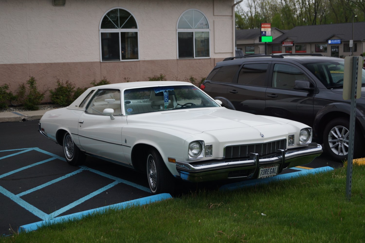 Front and side view of classic coupe with wire spoke wheels and chrome bumper