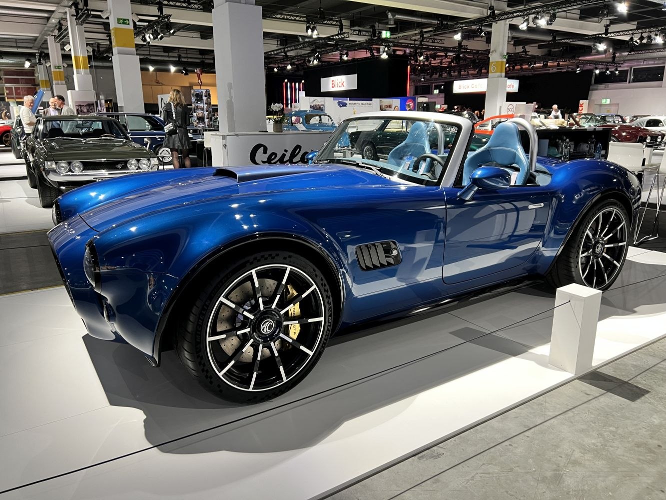 Blue convertible roadster with sporty alloy wheels and open-top design