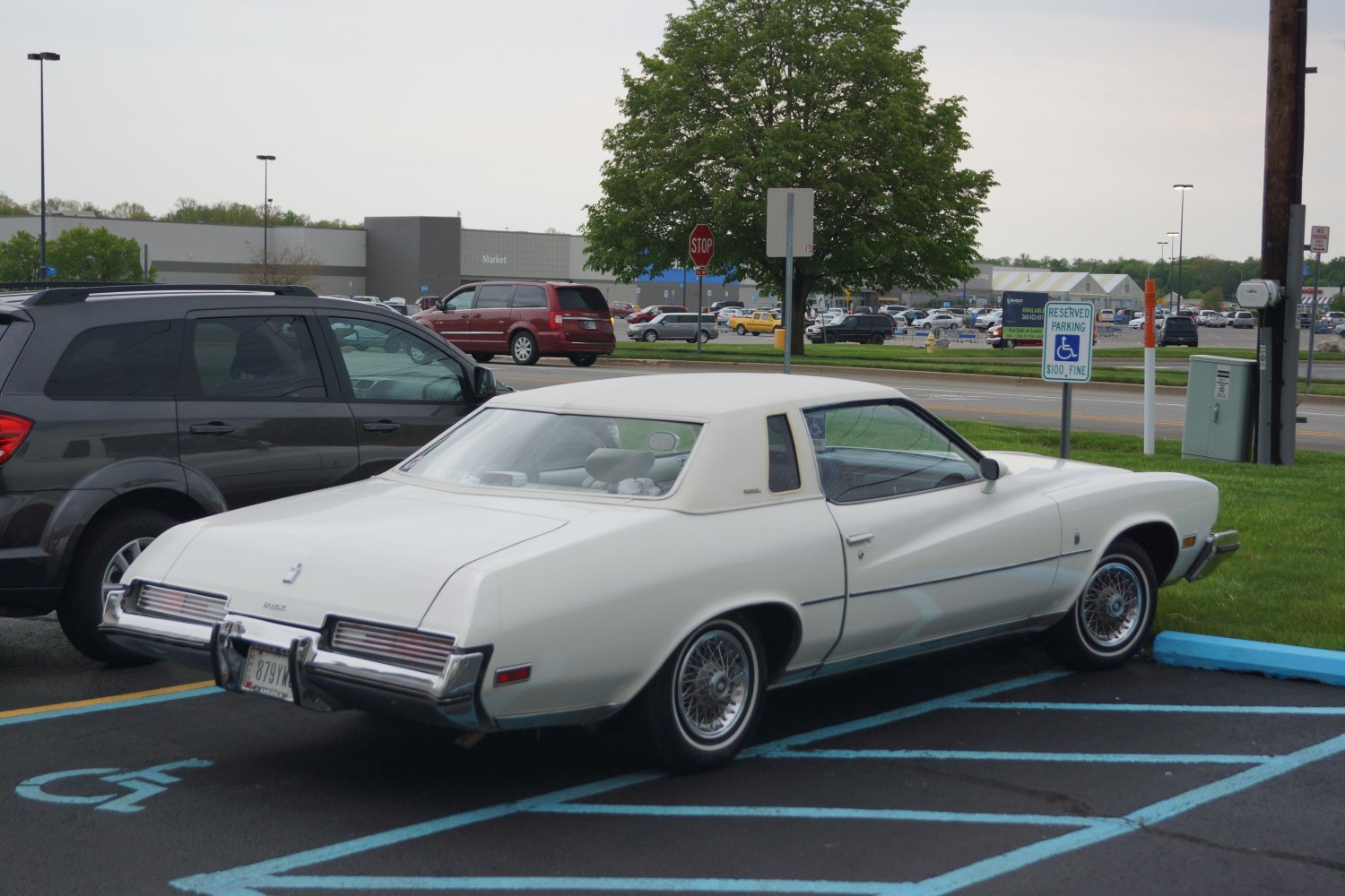 Two-door vintage coupe with vinyl roof and wire spoke wheels