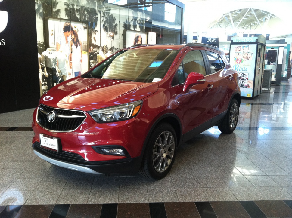 Red compact SUV front 3-quarter view with alloy wheels and modern headlights