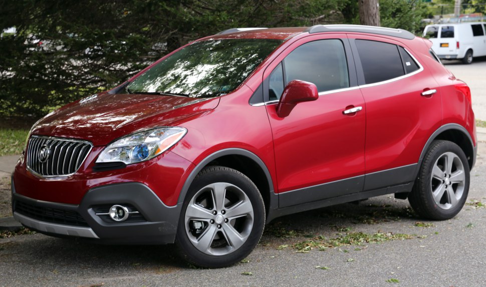 Front side view of a red compact SUV with chrome details and alloy wheels