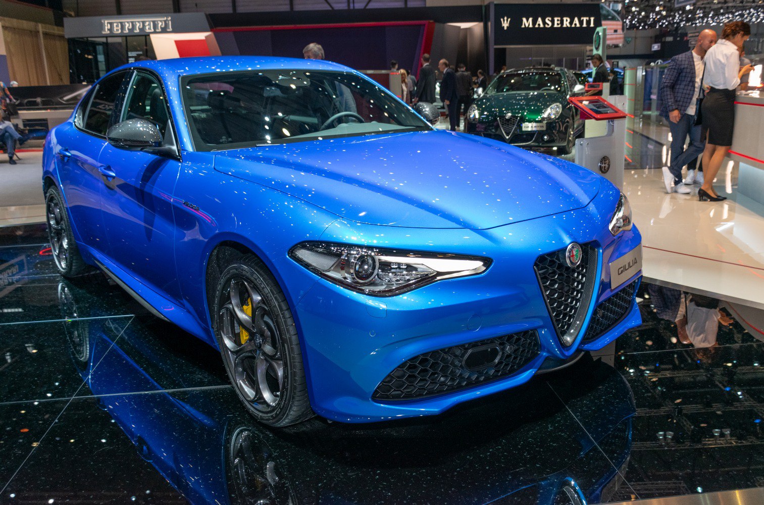 Sporty blue sedan with aggressive front grille and unique alloy wheels