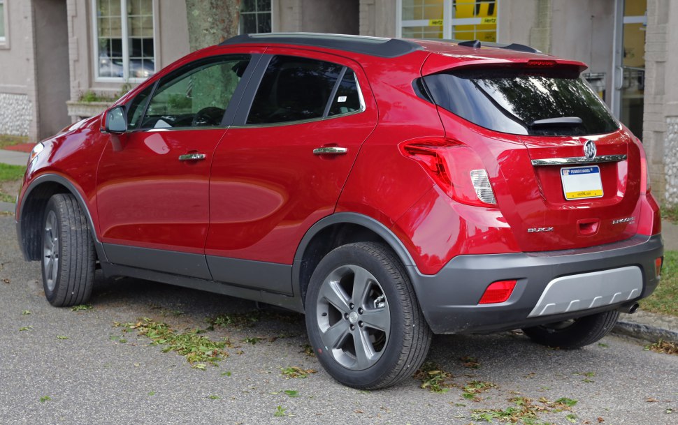 Red compact SUV rear side with alloy wheels and roof rails