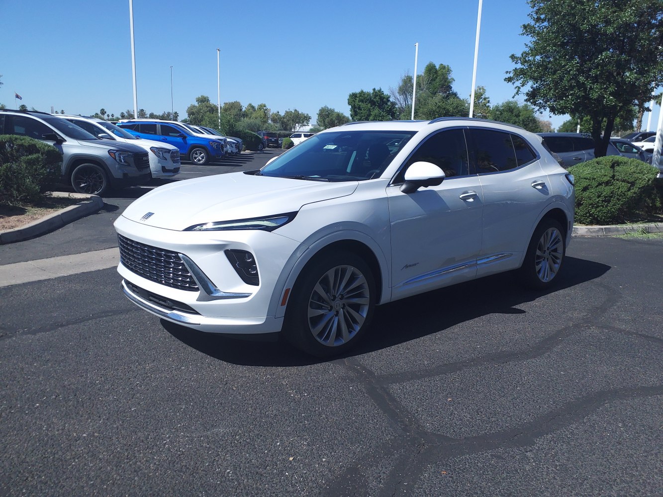 White SUV front three-quarter view with sleek grille and aerodynamic design