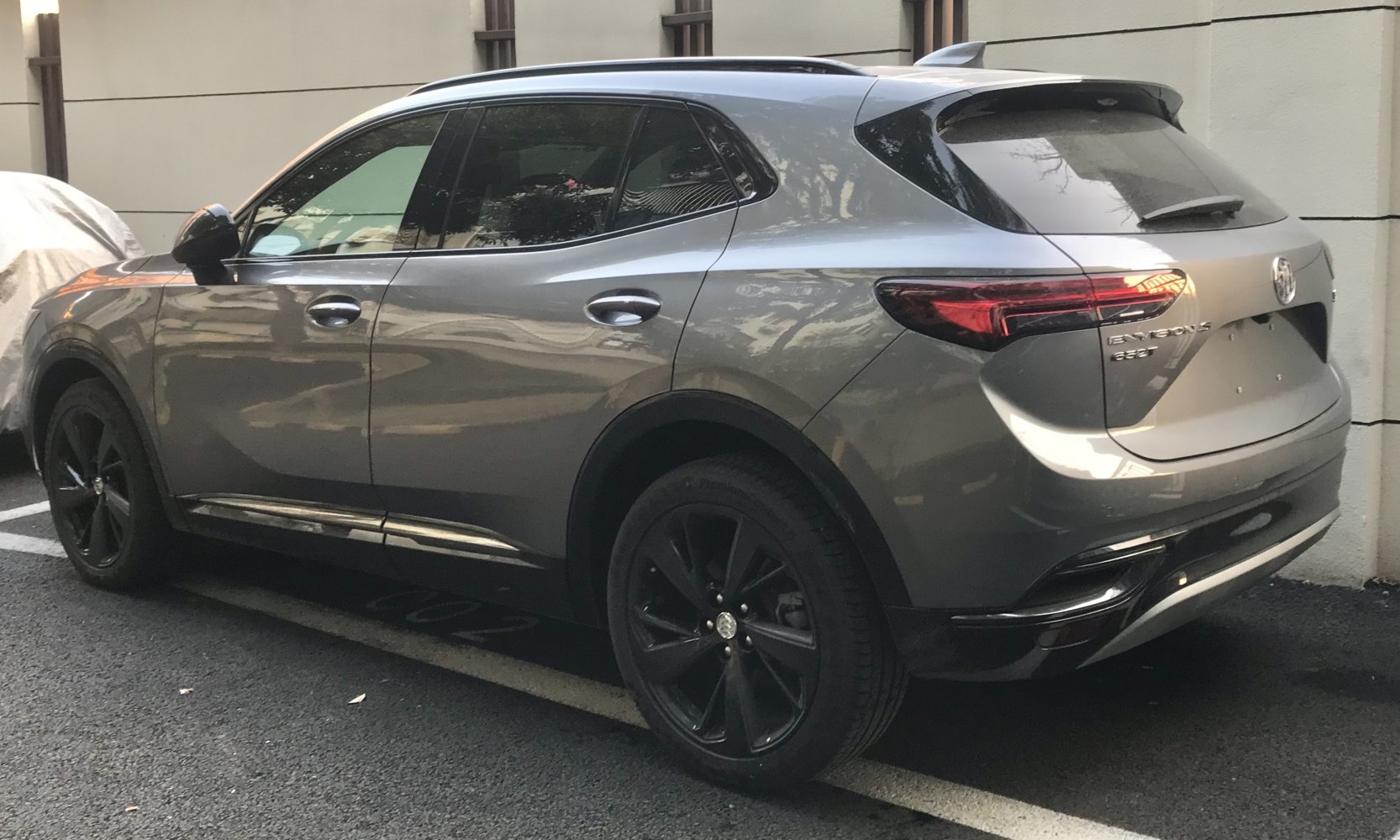 Rear and side profile with black alloy wheels and tinted windows