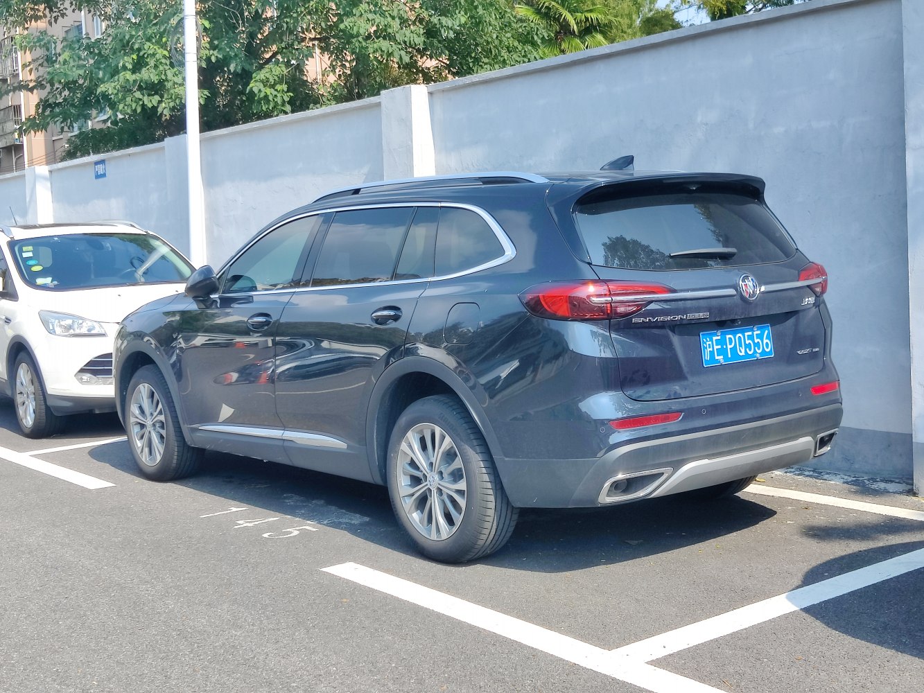 Rear exterior with tail lights, tinted windows, dual exhaust outlets
