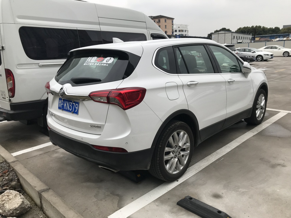 Rear and side view of white SUV with modern taillights and alloy wheels