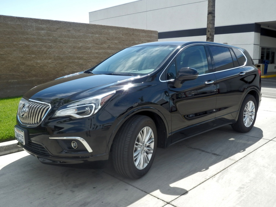 Front side view of black SUV with chrome grille and LED headlights