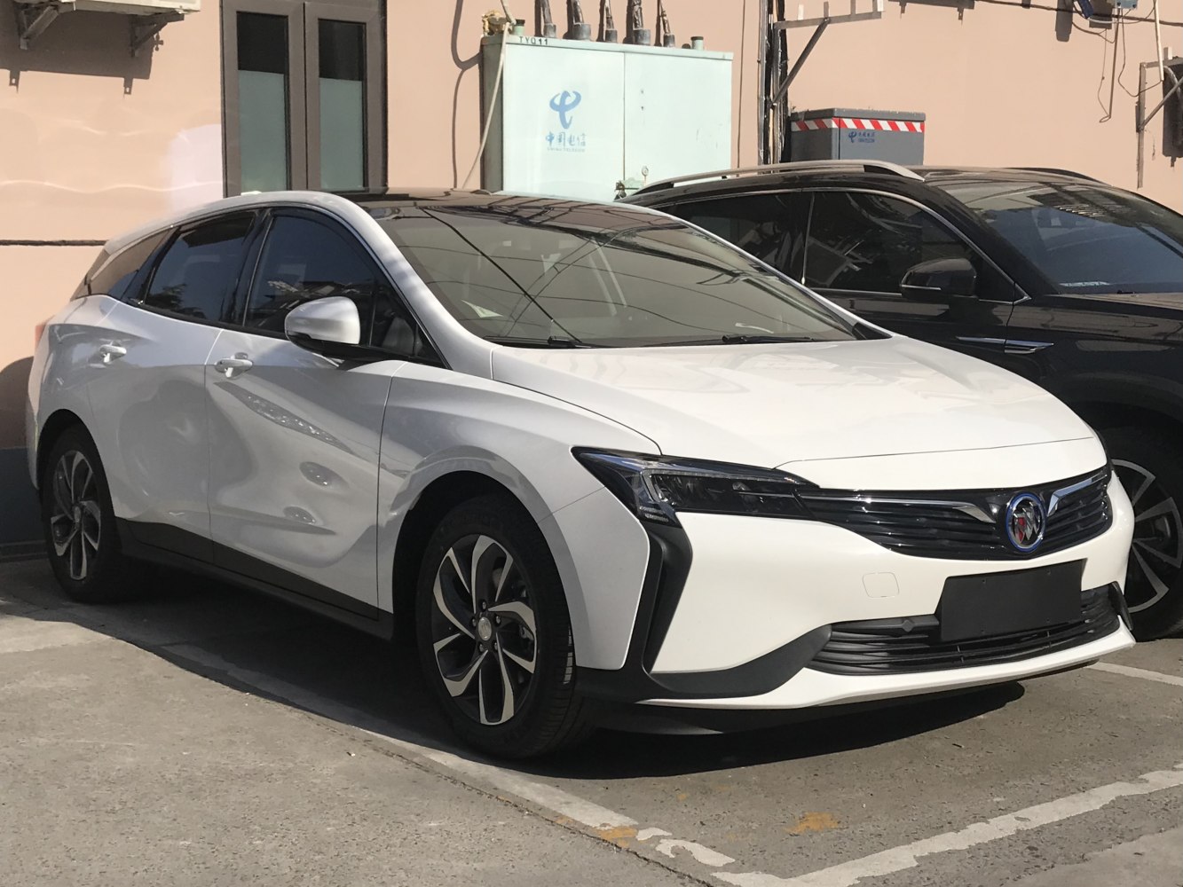 Front and side view of a sleek white compact wagon