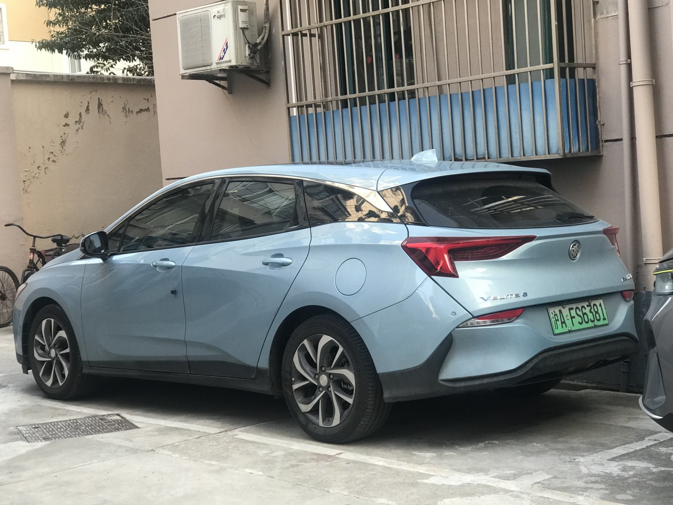 Rear and side view with modern taillights and aerodynamic hatchback design