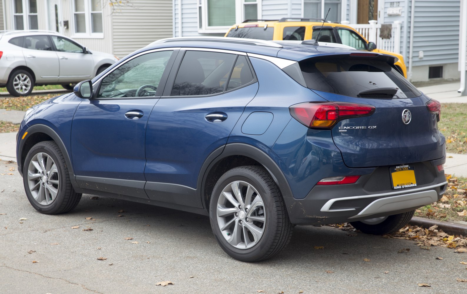 Rear side view of blue compact SUV with alloy wheels and roof rails