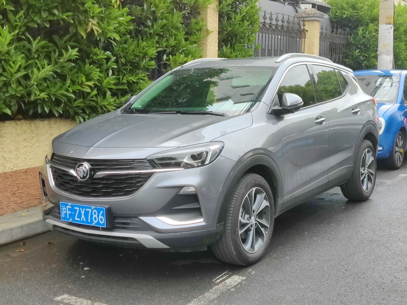 Front and side view of grey SUV with LED headlights and black grille