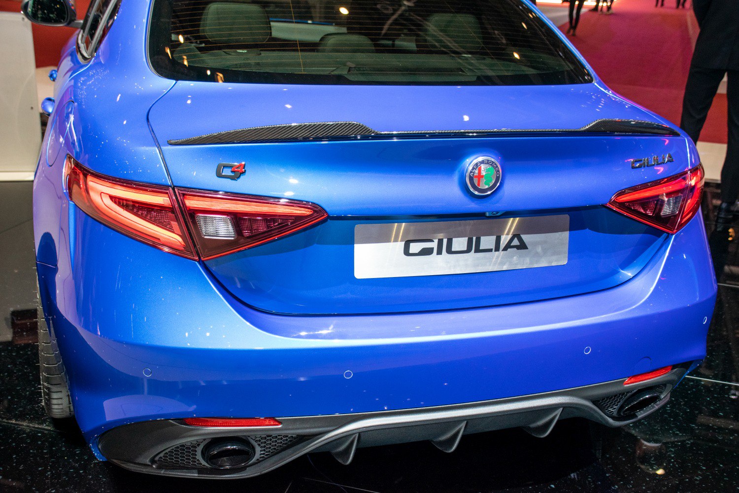 Rear view with taillights, carbon fiber spoiler, exhaust, and diffuser
