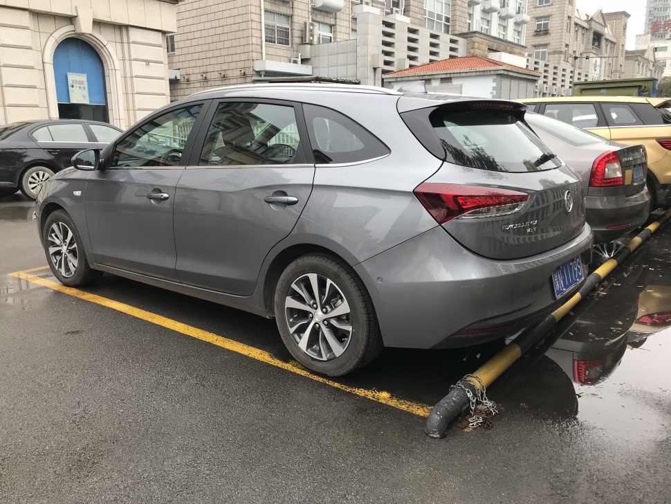 Gray 5-door hatchback with alloy wheels and sleek aerodynamic design.