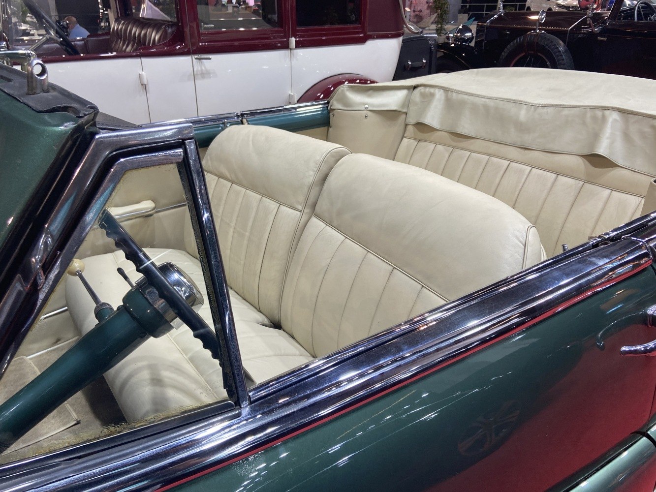 Convertible interior with cream leather seats and dark green steering column