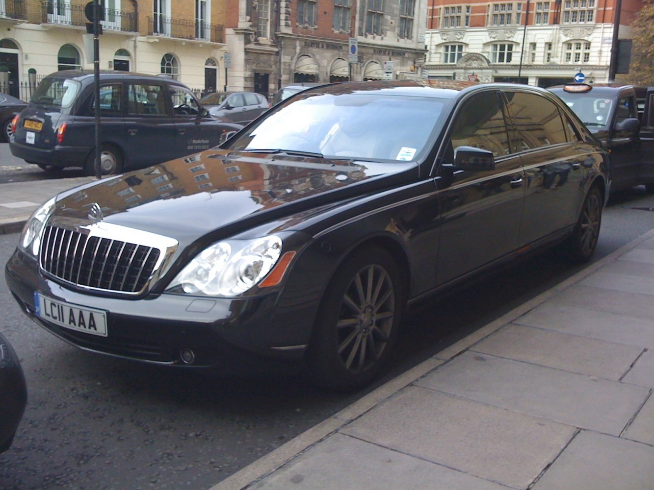 Luxury sedan with prominent front grille and oval headlights in black
