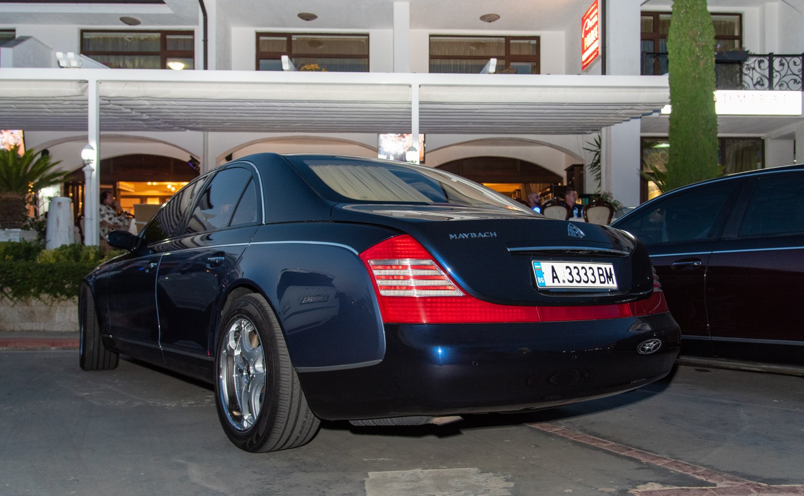 Luxury sedan rear with distinctive tail lights and smooth body contours