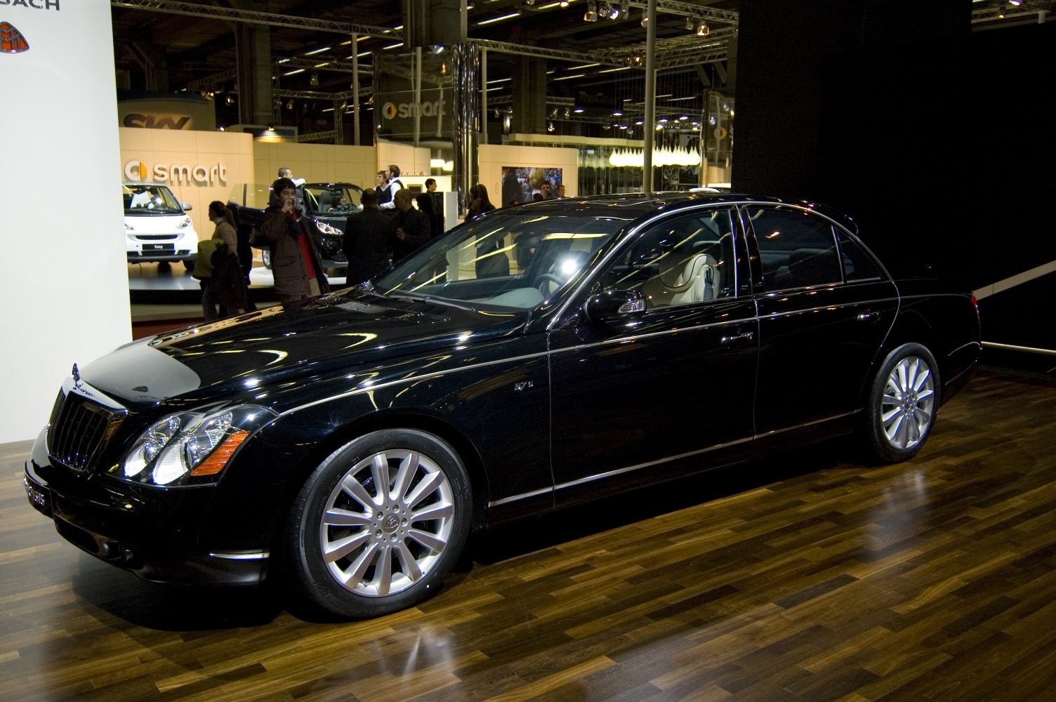 Luxury black sedan with multi-spoke alloy wheels and visible interior