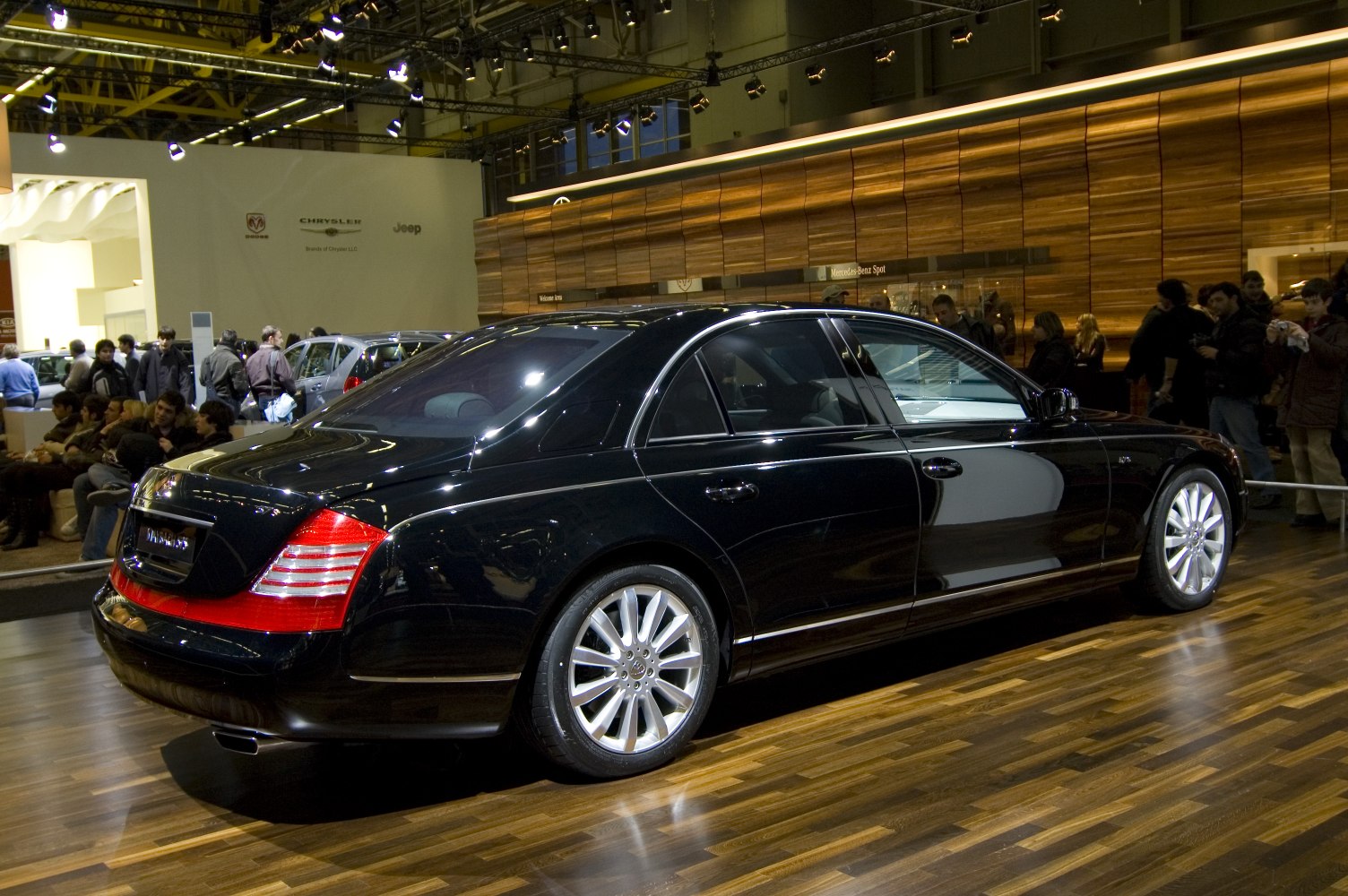 Rear side view of a black luxury sedan with multi-spoke alloy wheels.