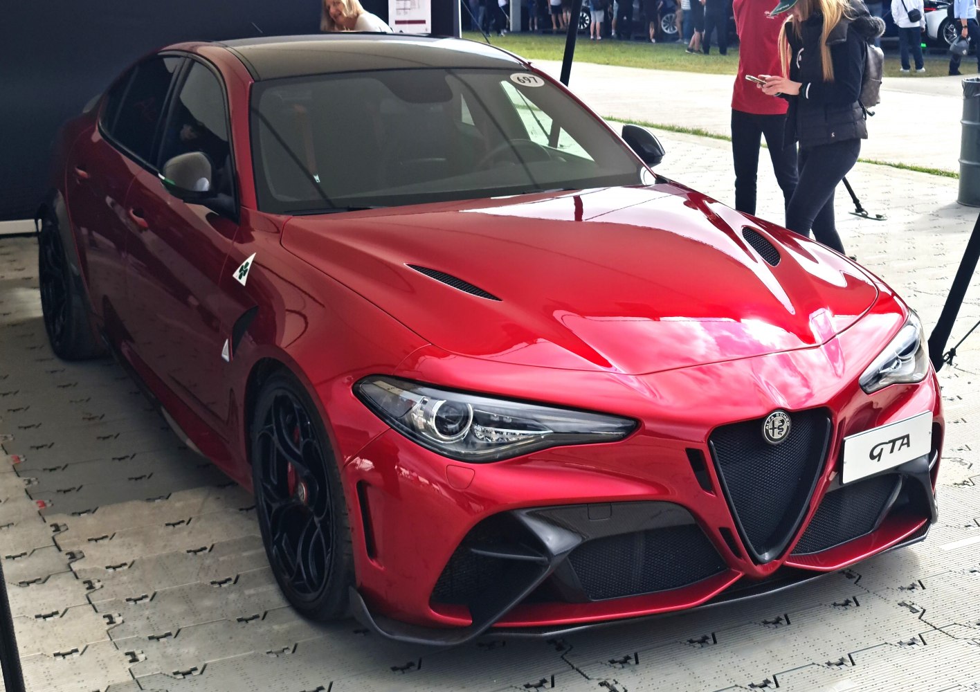 Red sporty front with hood vents and aggressive aerodynamic styling.