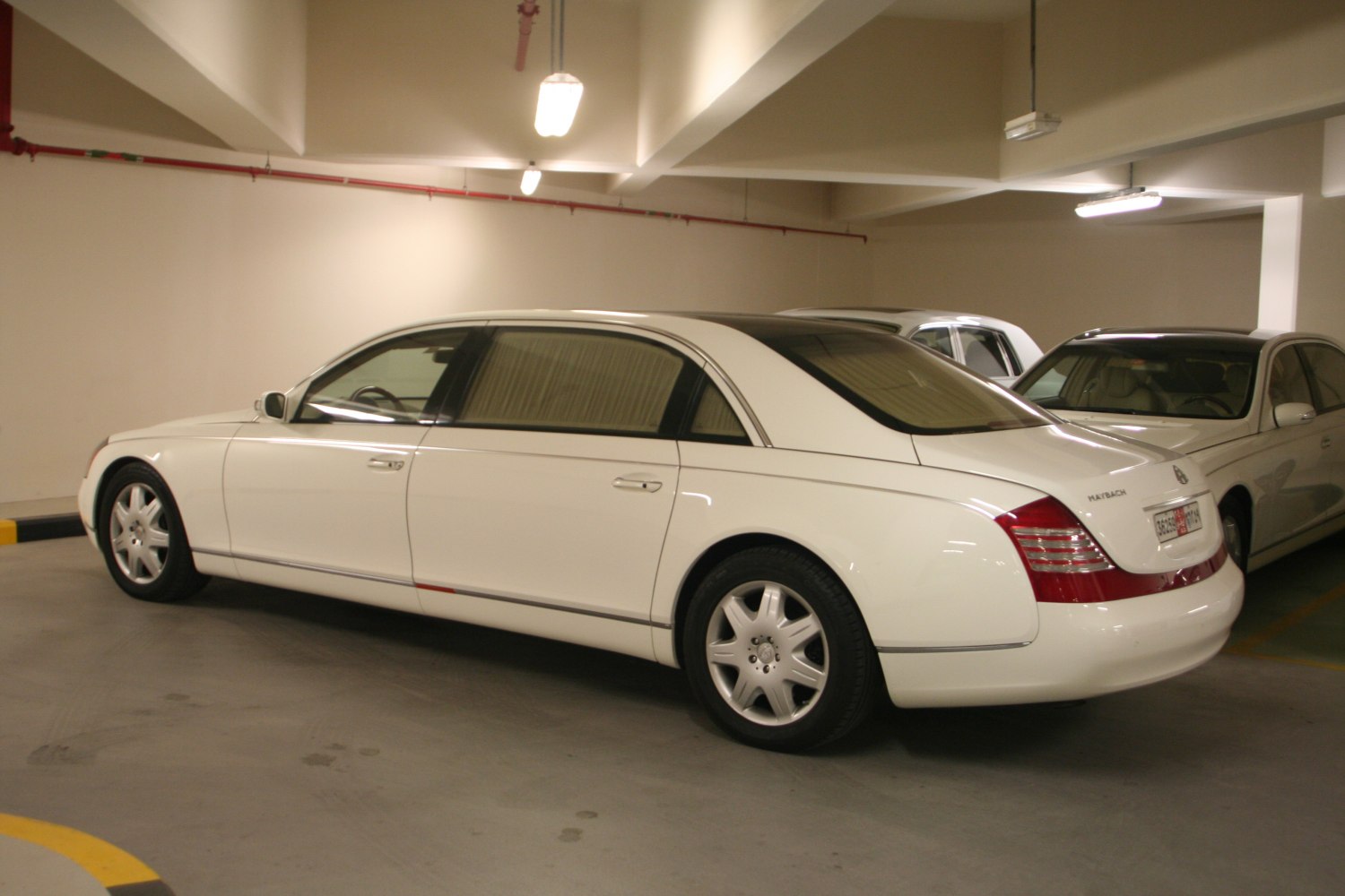 White extended wheelbase luxury sedan in side profile view