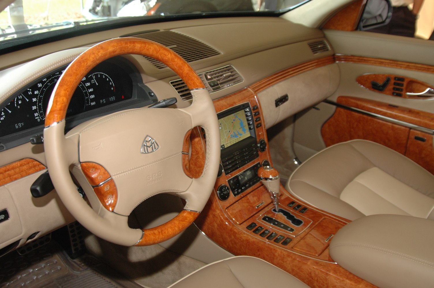 Beige leather interior with wood trim and advanced navigation system